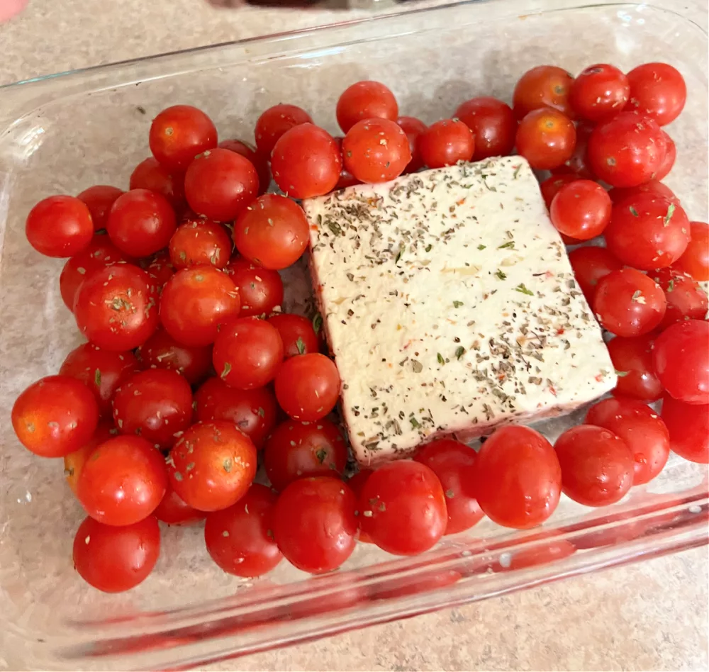 9x13 baking dish with feta cheese and cherry tomatoes 