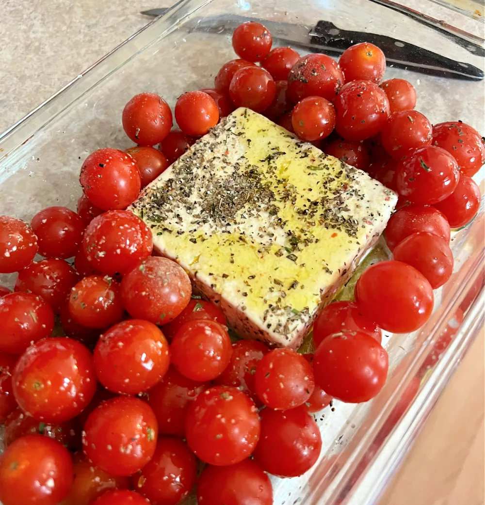 9x13 baking dish with feta cheese and cherry tomatoes