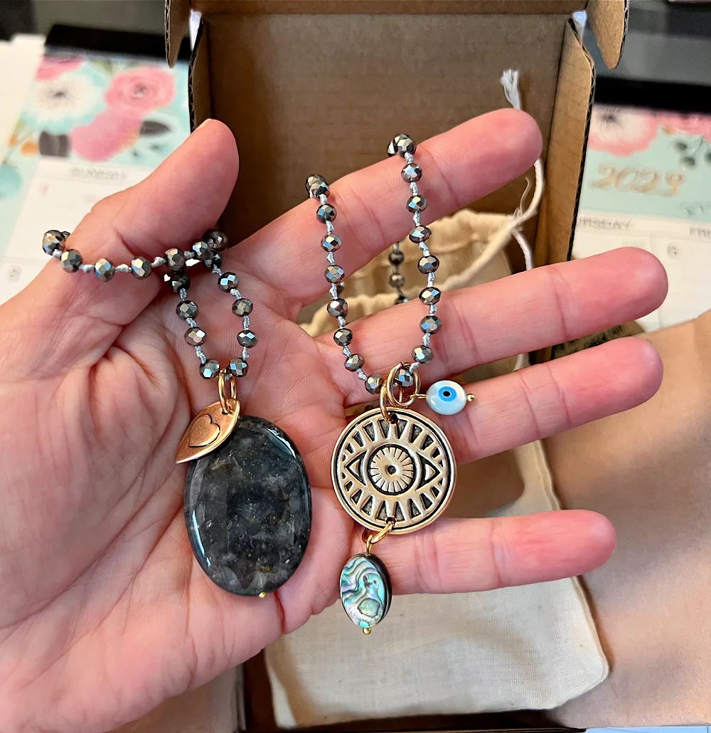 katia designs necklace featuring an evil eye and cloudy quartz and abalone