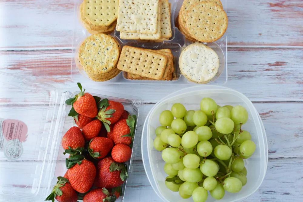 green grapes, strawberries and an assortment of crackers to make a charcuterie 
