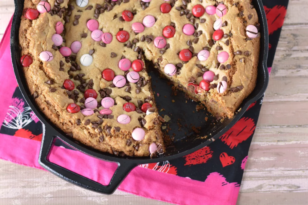 Chocolate Chip Giant Cookie with red and pink M&Ms in a cast iron skillet