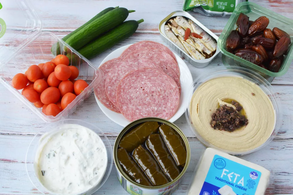 crunchy cucumbers, feta cheese, salami, pita crackers, sardines, and kalamata olives