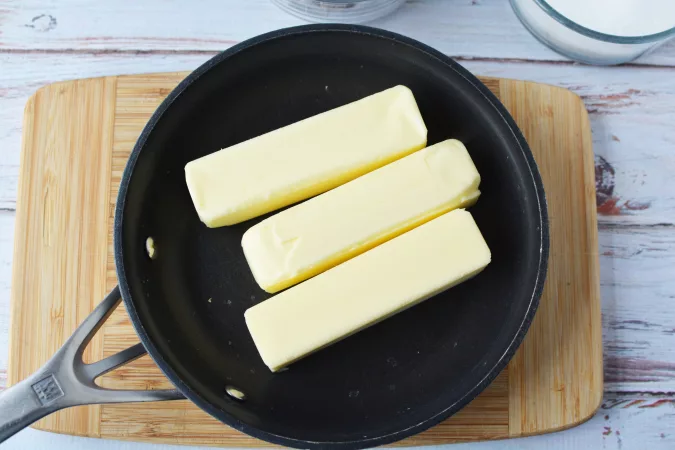 three sticks of butter in a pan