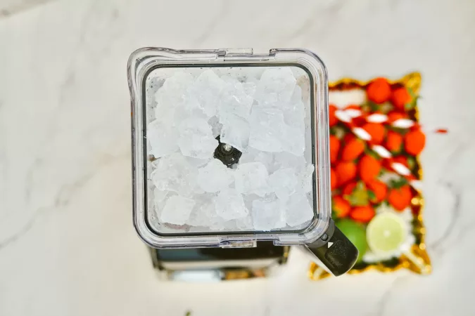 Frozen Berry Margarita with ice in the blender