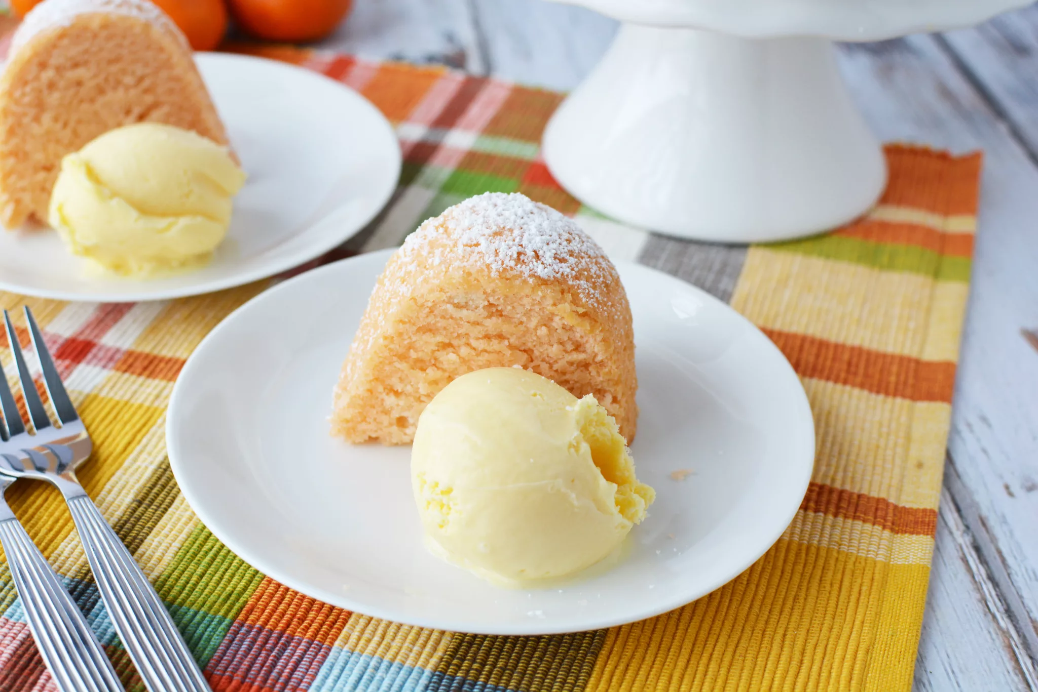 orange colored bundt cake with vanilla ice cream