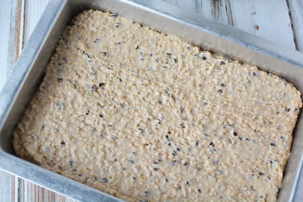 raw oatmeal cookie batter in a baking pan