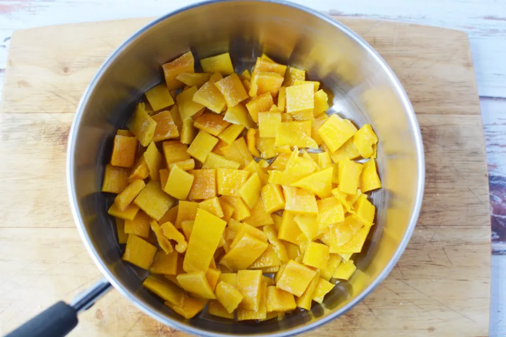 chunks of mangoes in a sauce pan