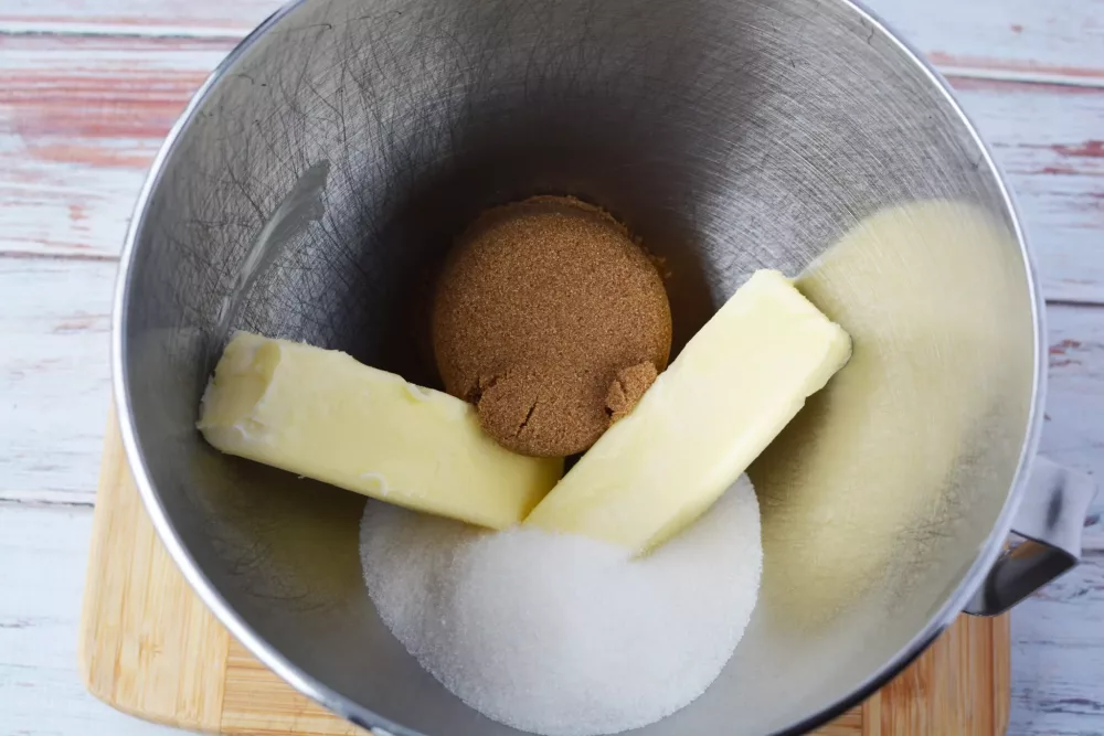 Next, in a separate mixing bowl, add your butter and sugars.