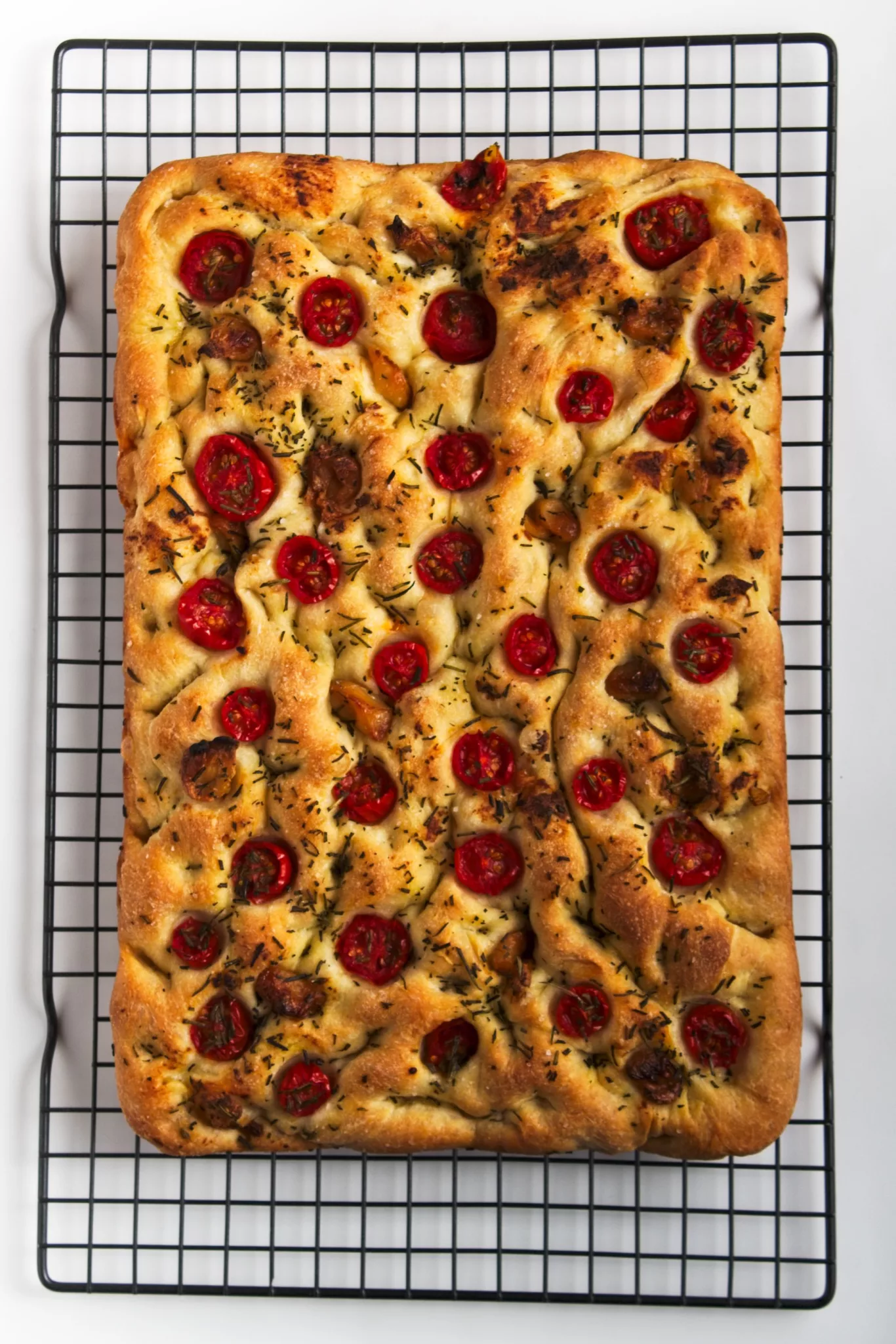 Roasted Garlic Focaccia resting on a cooling rack