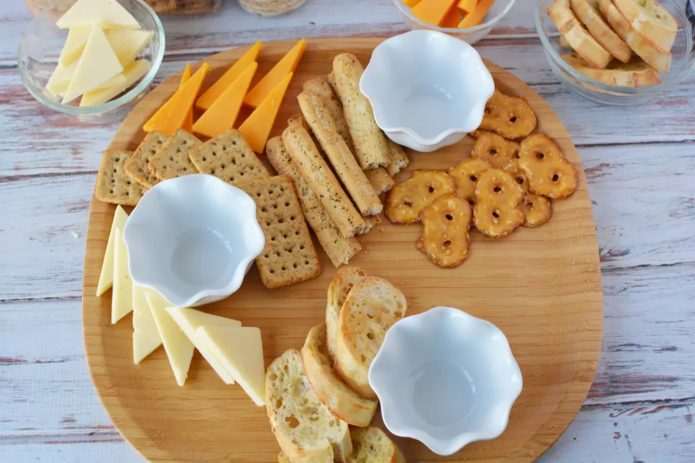 cheese board filled with crackers and cheeses