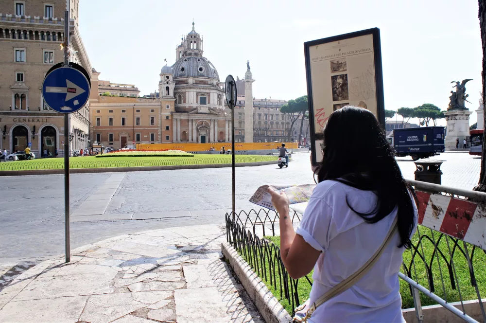Jennifer Pridemore walking through the streets of Rome with a map in hand
