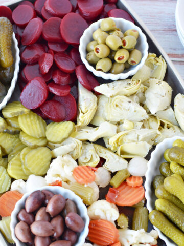 Pickle Charcuterie Board filled with pickled vegetables