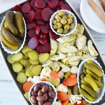 pickle charcuterie board filled with an assortment of pickled vegetables