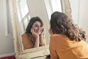 young woman looking into a mirror