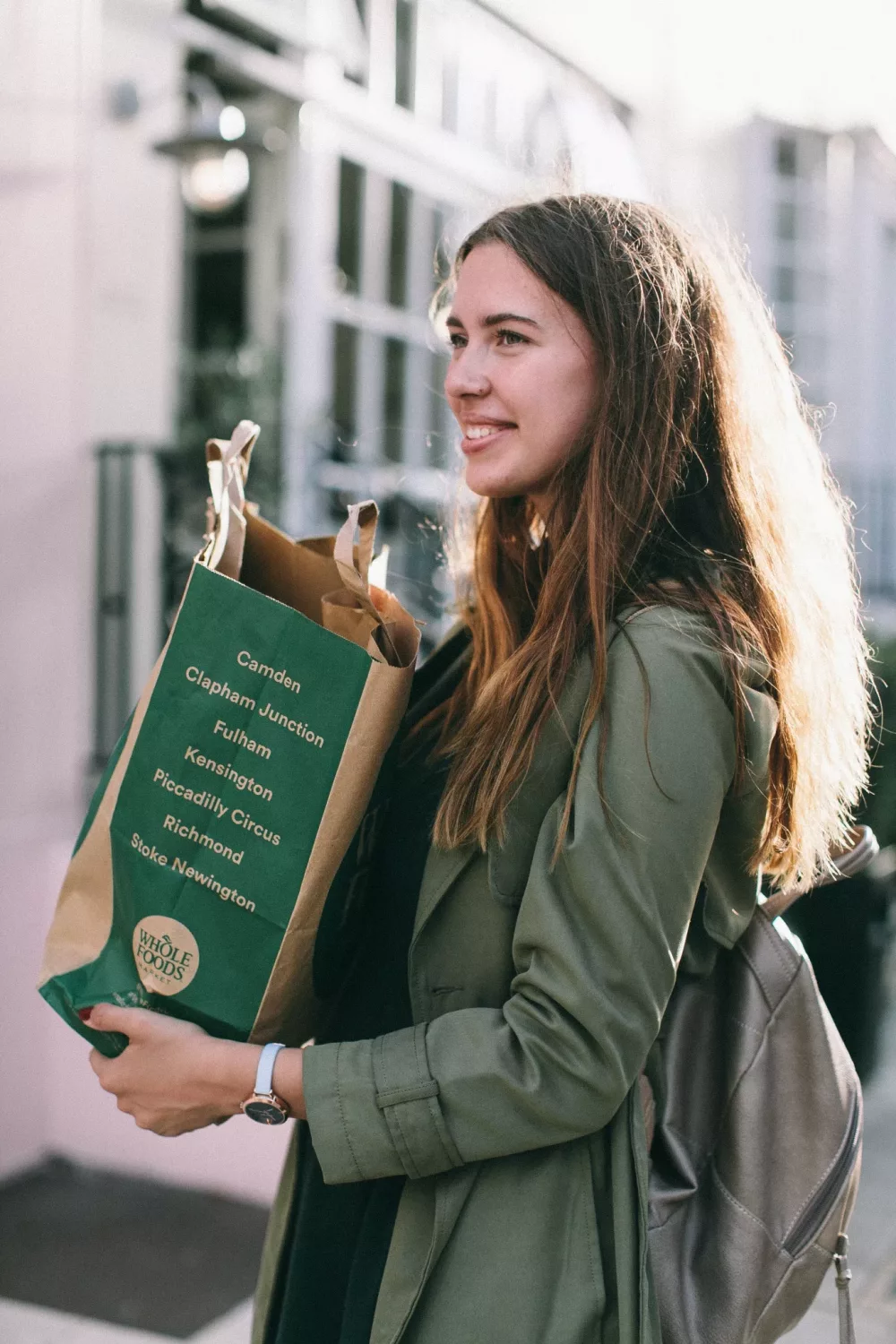 young woman holding a bag of groceries