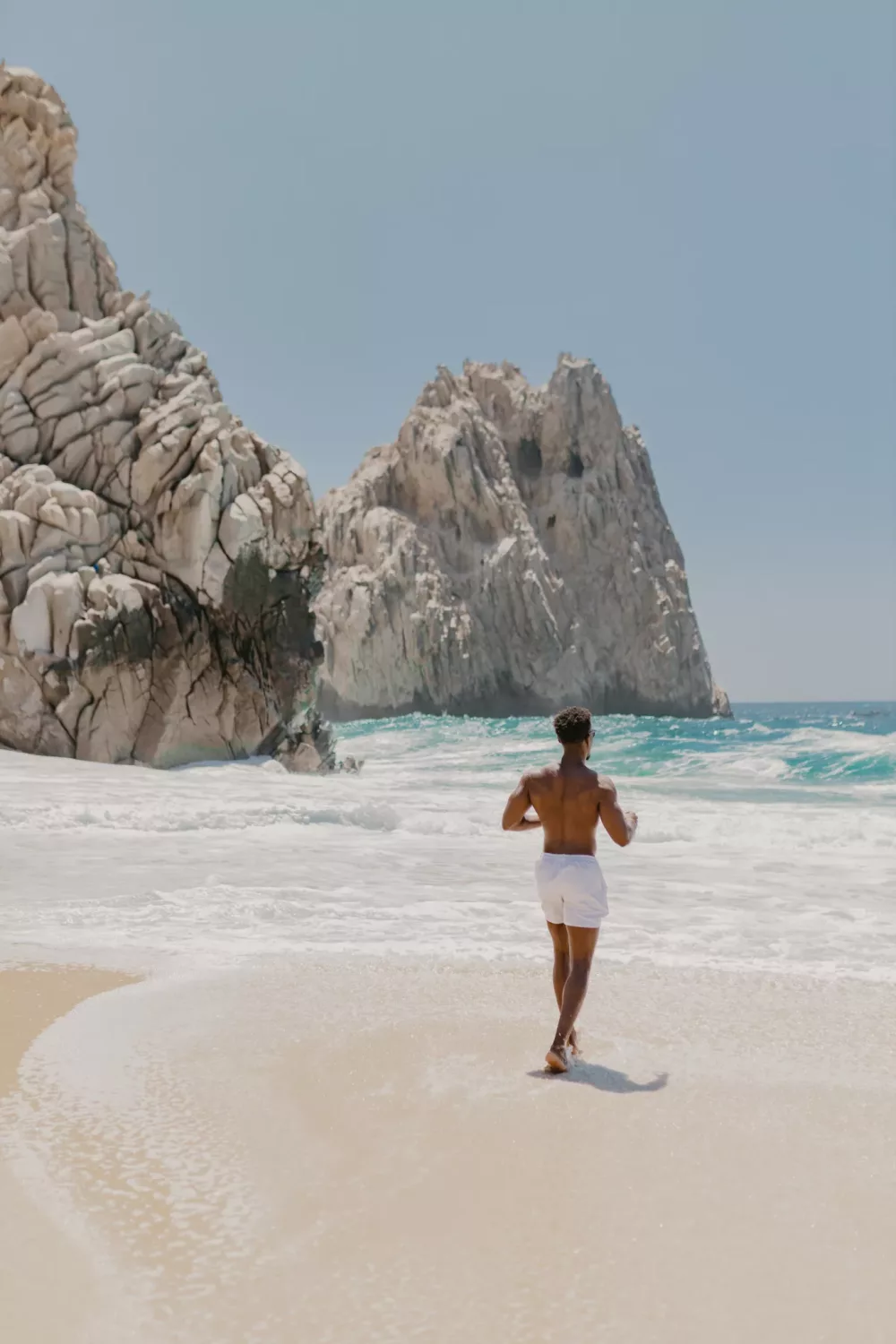 man running on the beach in Cabo San Lucas