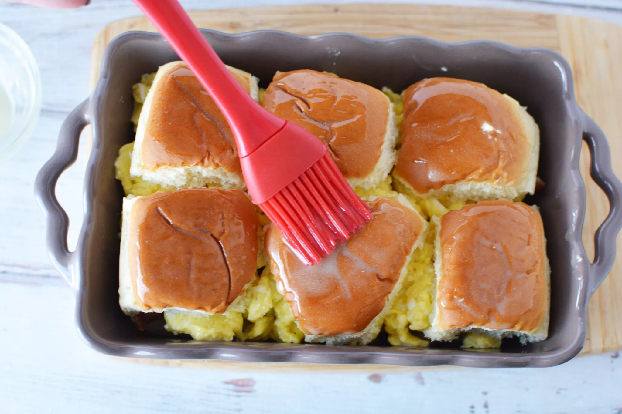 pastry brush brushing butter over rolls