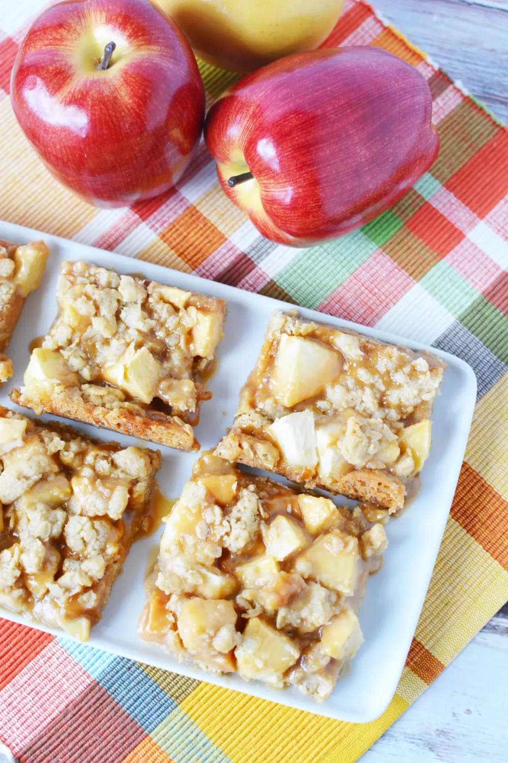 bars covered in chunks of apples, caramel and oatmeal 