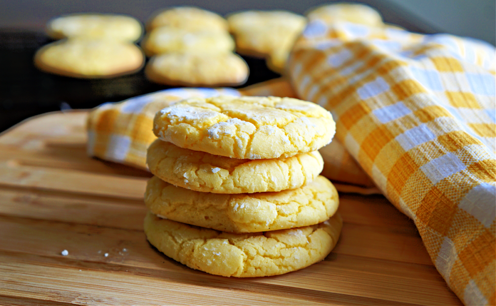 yellow lemon cookies on a wooden cutting board
