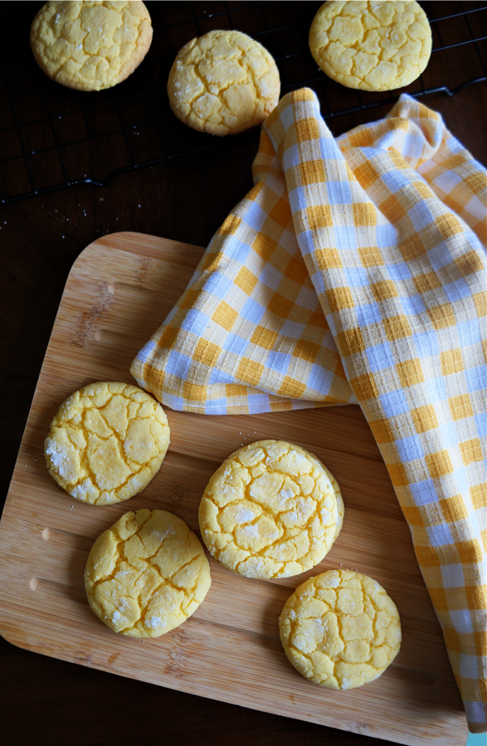 yellow lemon cookies on a wooden cutting board