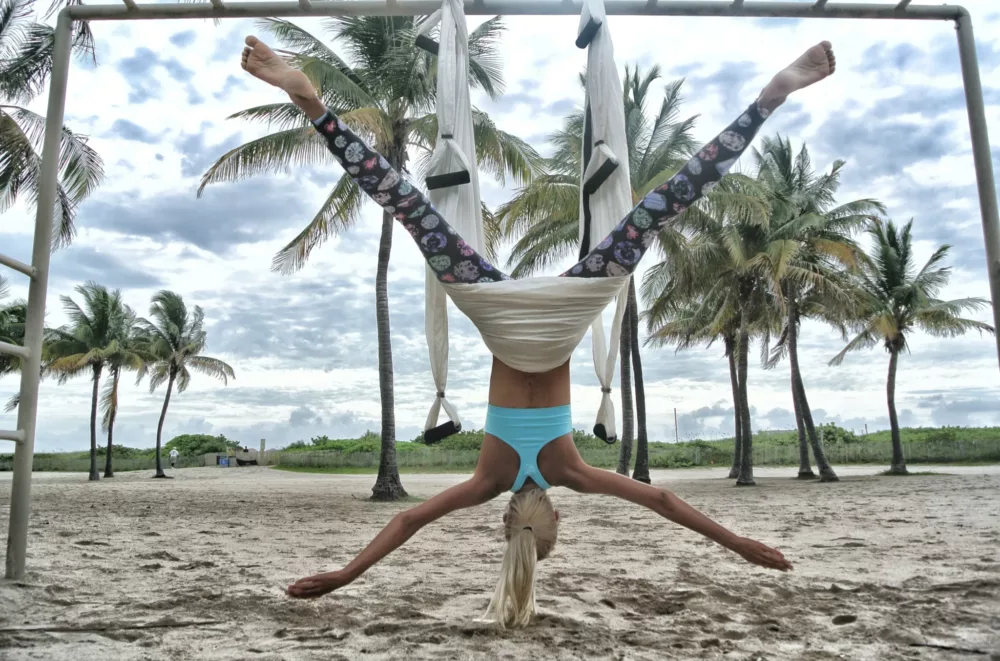 person doing yoga at the beach