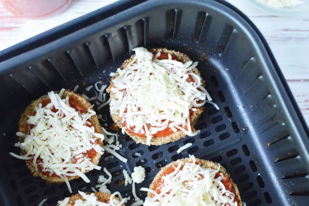 breaded slices of eggplant topped with shredded mozzarella cheese