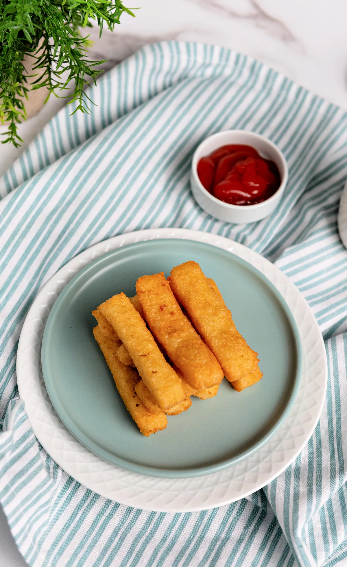 Potato Cheese Sticks on a plate with dipping sauces in the background