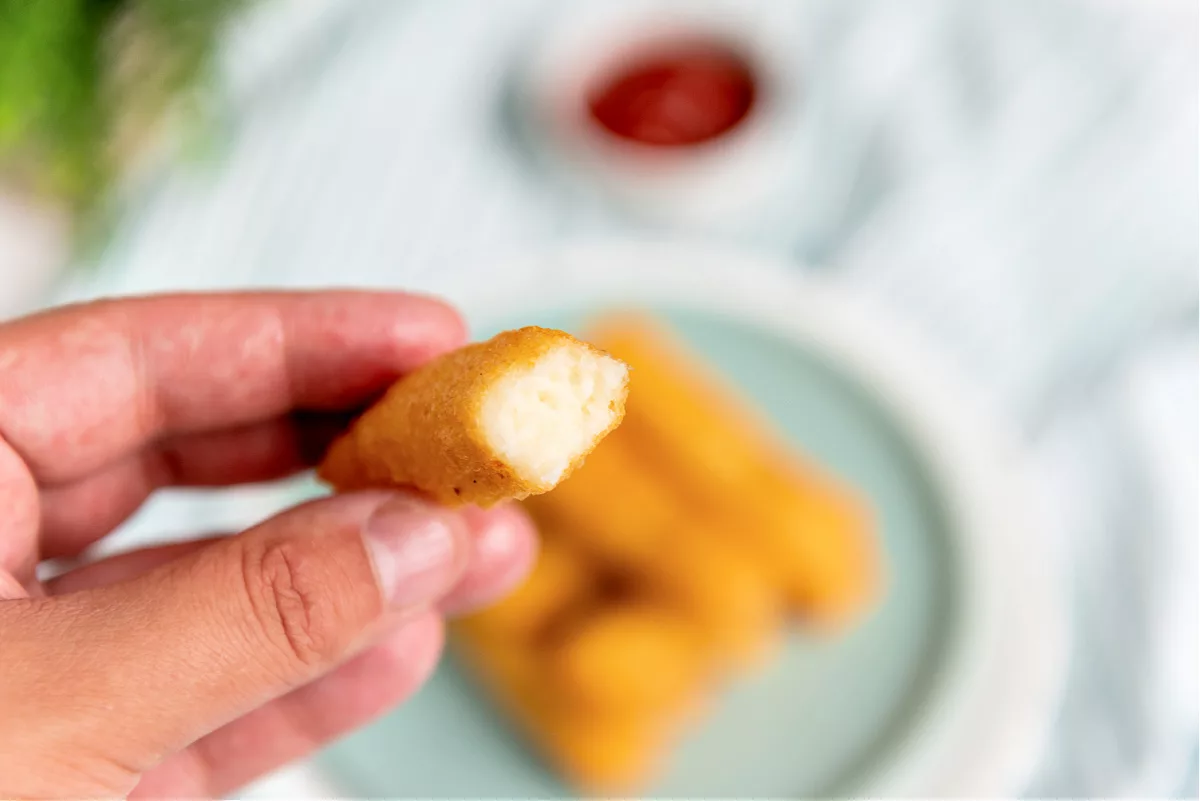 Potato Cheese Sticks on a plate with dipping sauces in the background