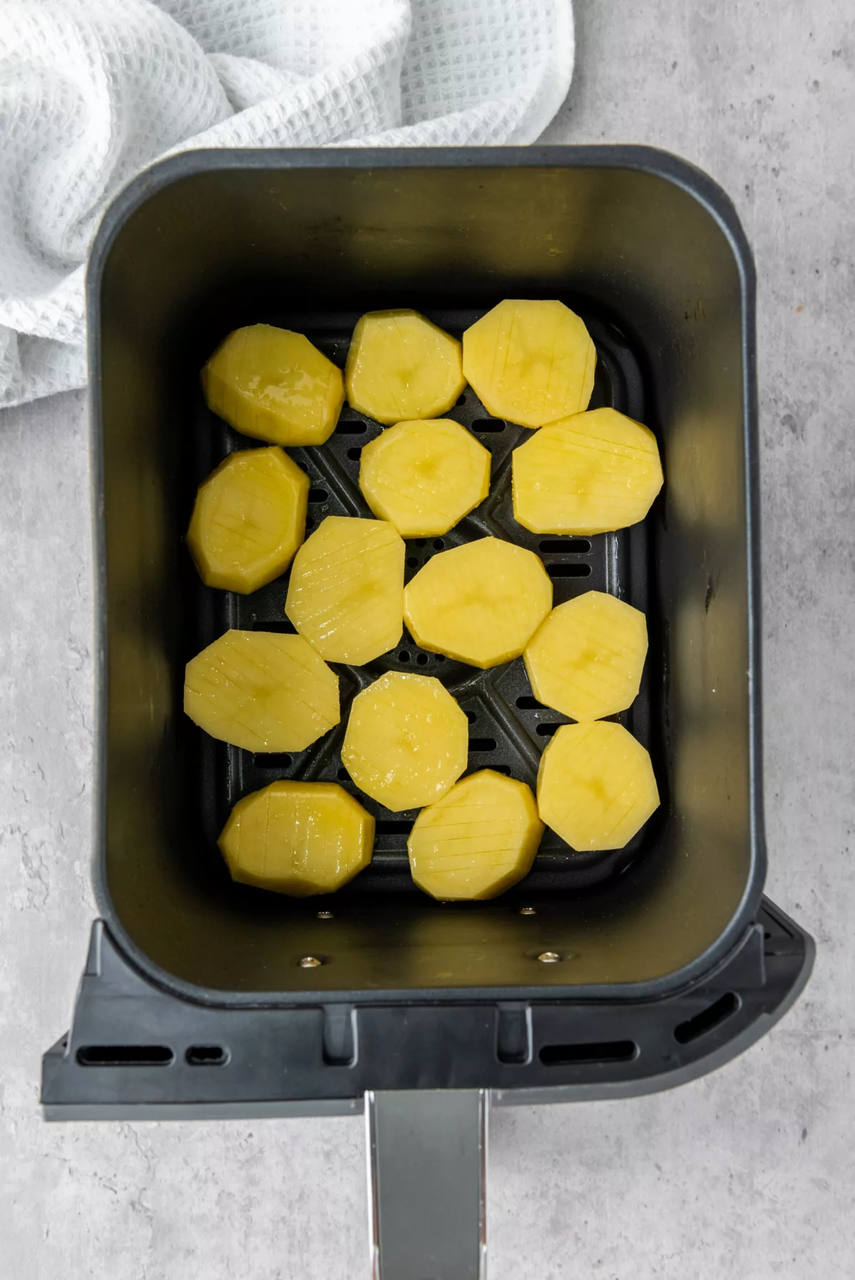 potatoes in an air fryer basket