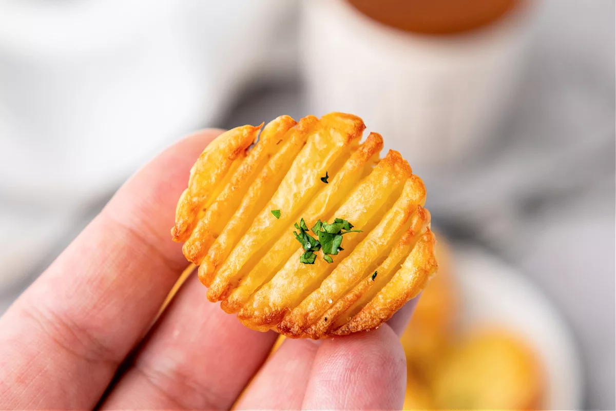 accordion potatoes on a plate topped with parsley
