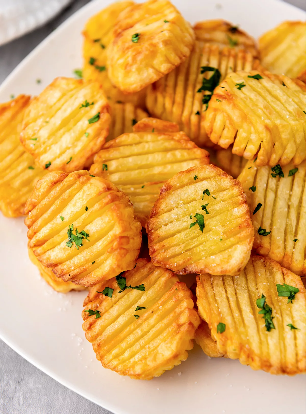 accordion potatoes on a plate topped with parsley