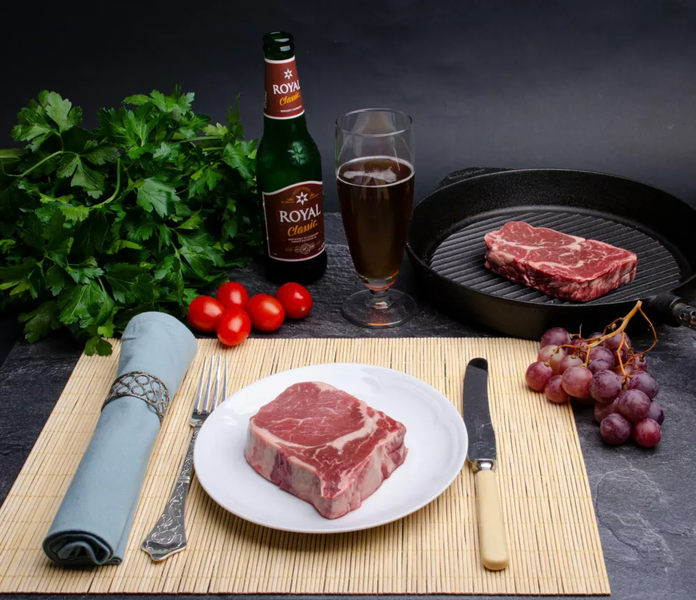 raw steak on a wooden cutting board