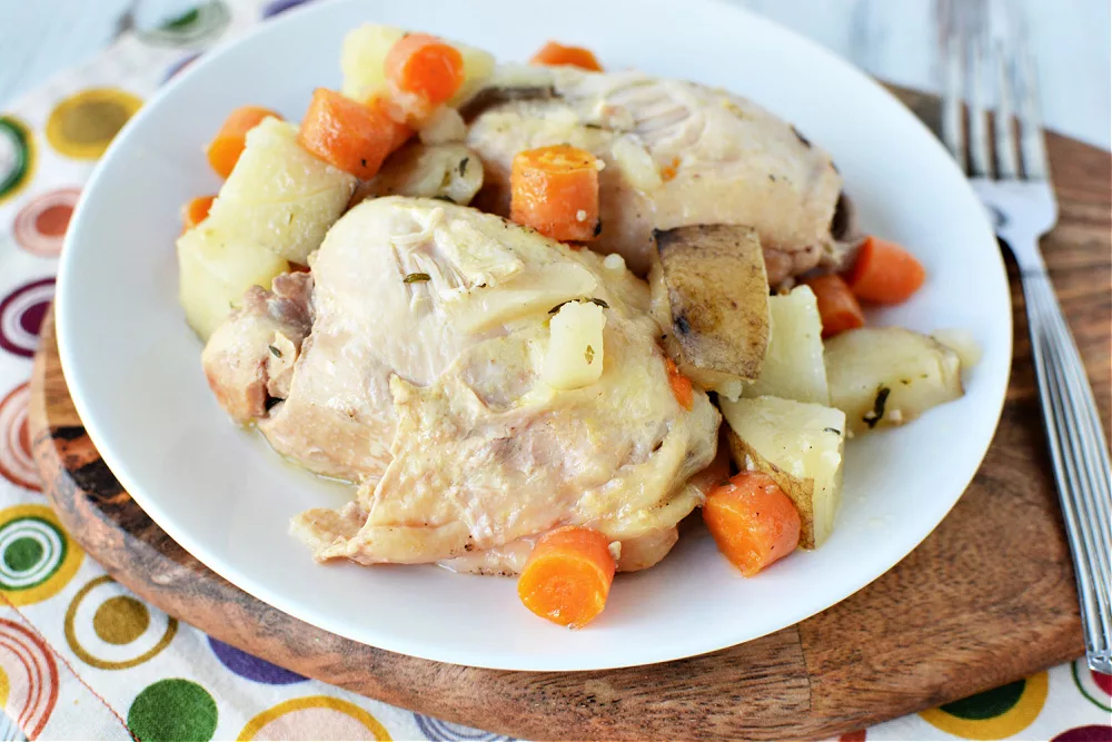 Chicken with Potatoes and carrots on a white plate