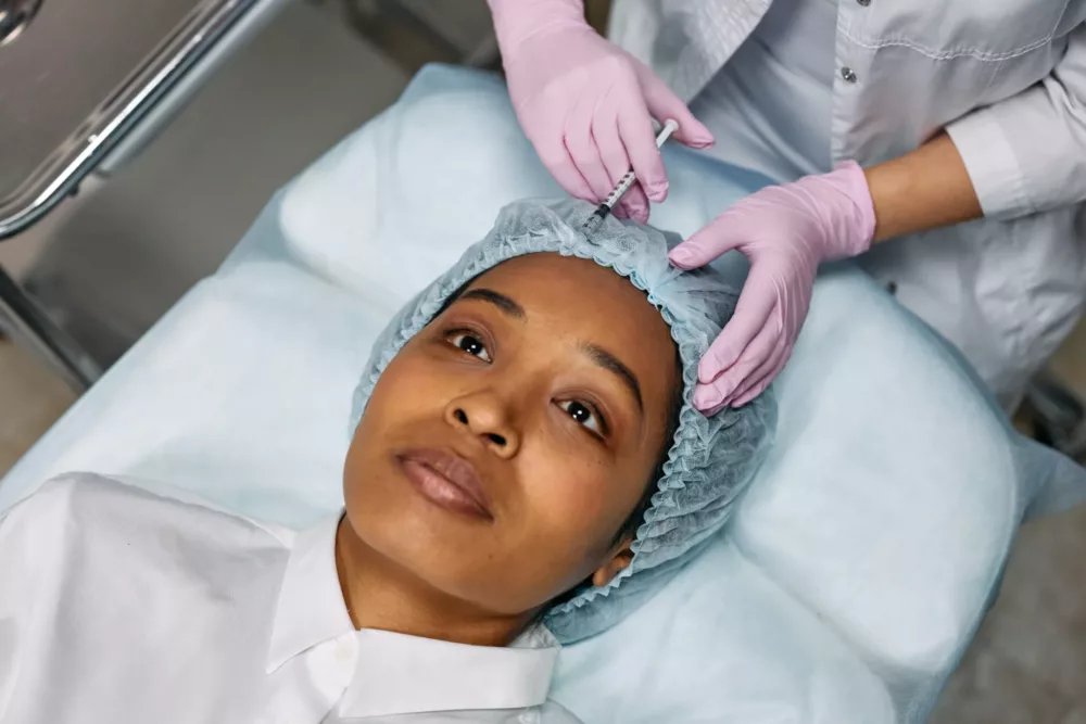 woman getting injections in her forehead