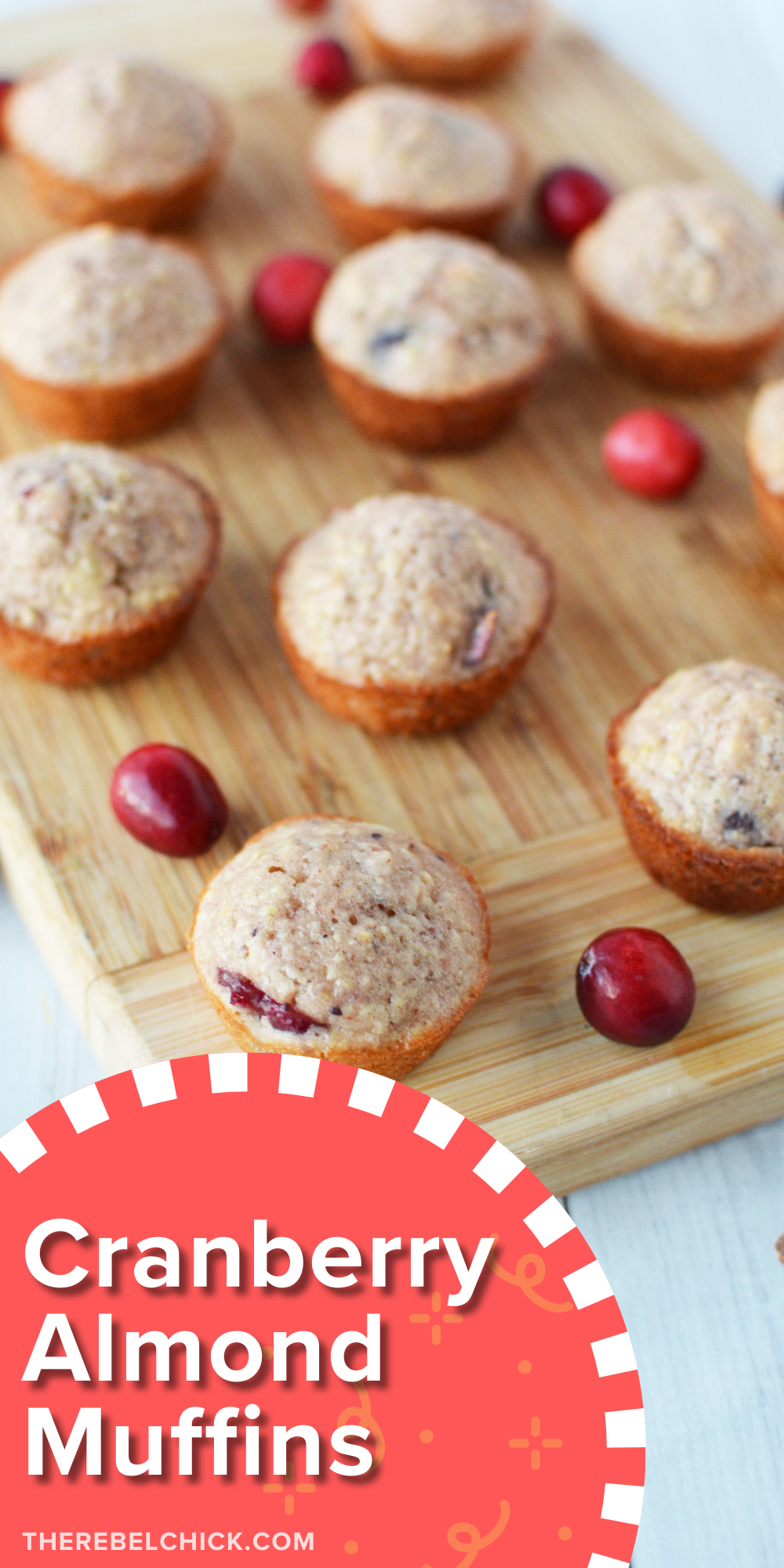 Mini Muffins on a wooden cutting board with fresh cranberries and sliced almonds