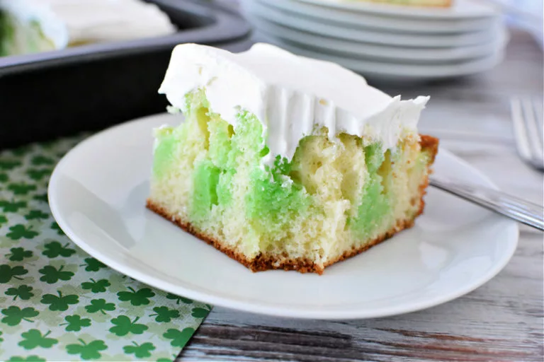 a cake with whipped frosting, and lime jello streaks throughout.