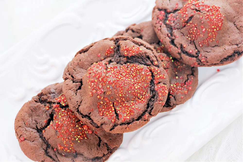 A chocolate cookie with sprinkles.