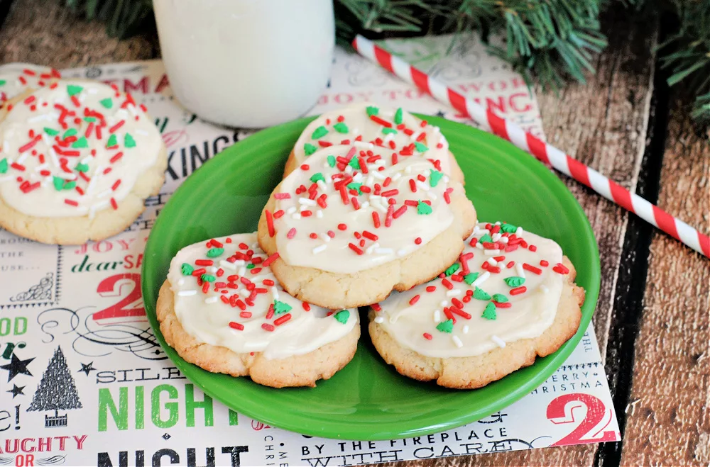 A plate of cookies frosted and sprinkled for Christmas.