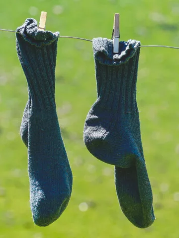 a pir of socks hanging on a clothesline