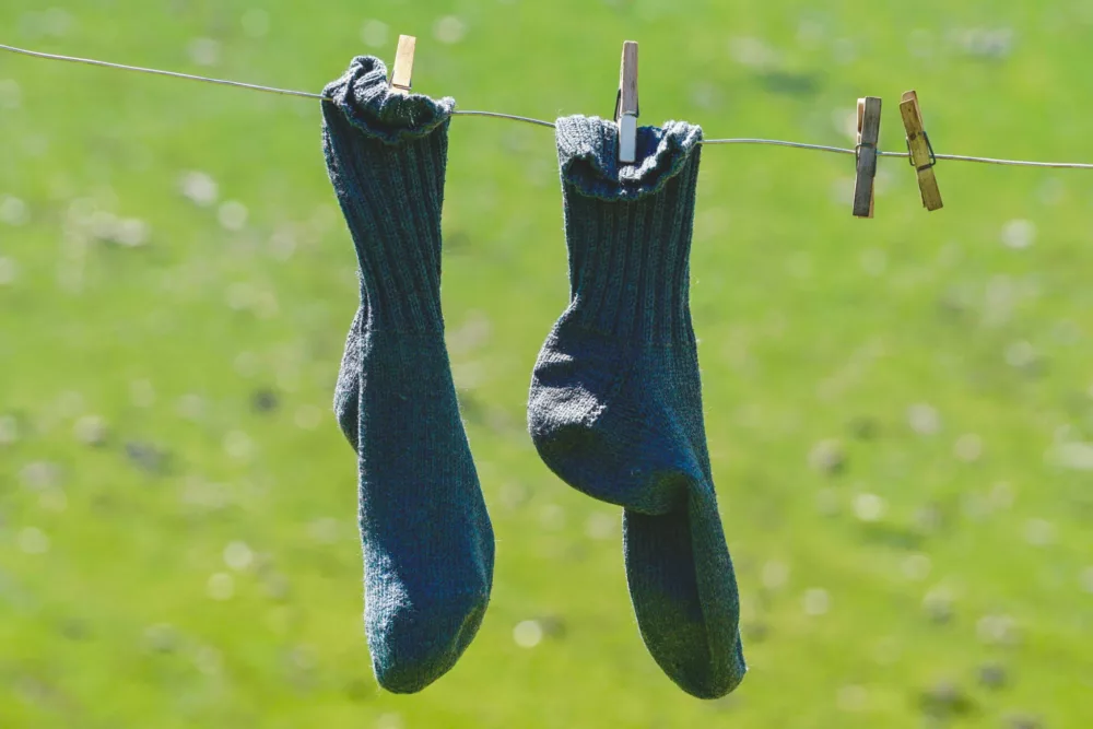 a pir of socks hanging on a clothesline