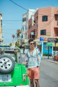 man in green shorts getting into a car in miami