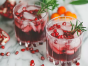 Pomegranate Wine in a glass with ice and seeds