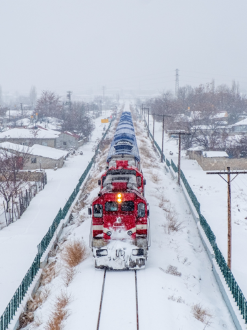 train going through a snowy countryside