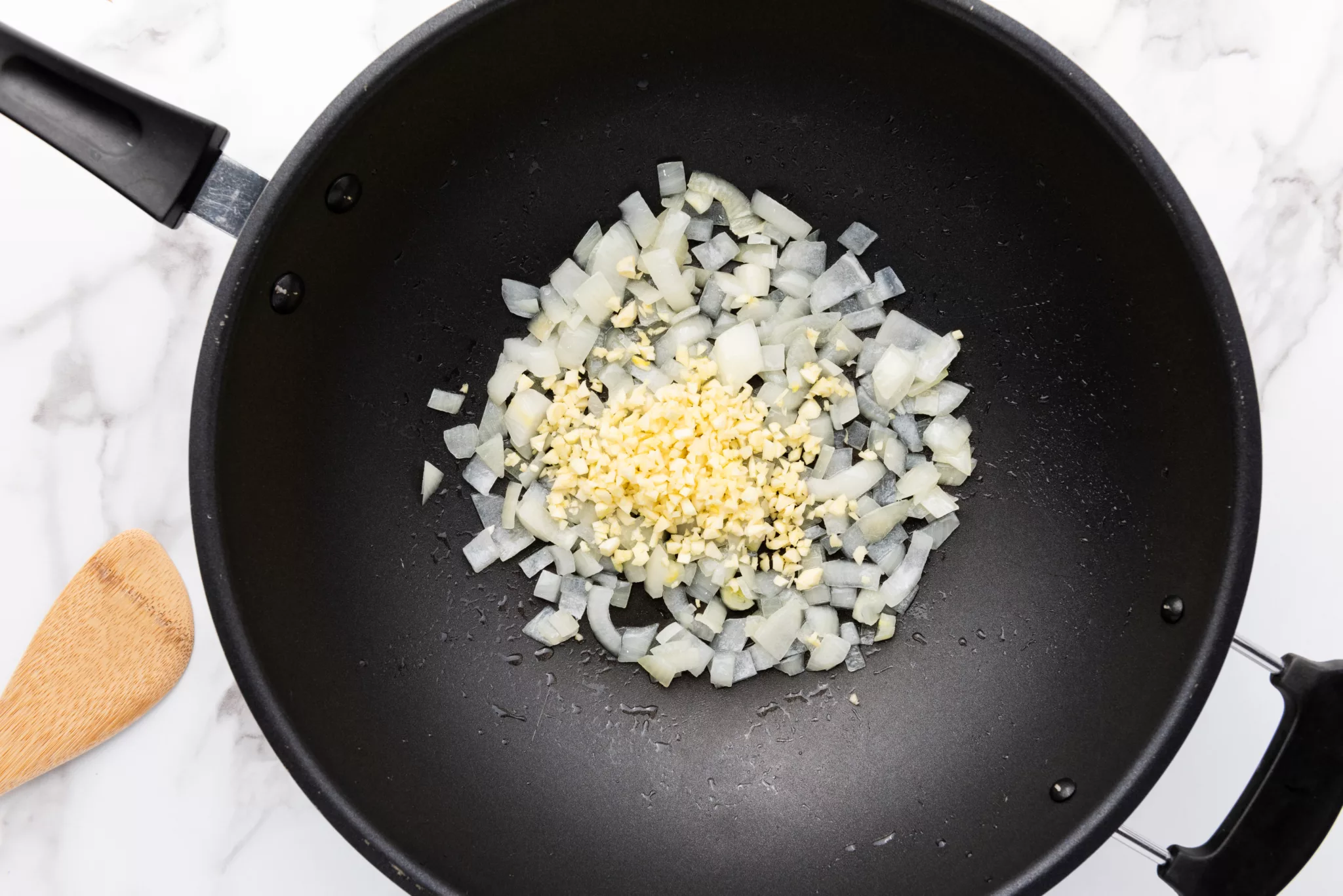 diced onions and minced garlic in a frying pan