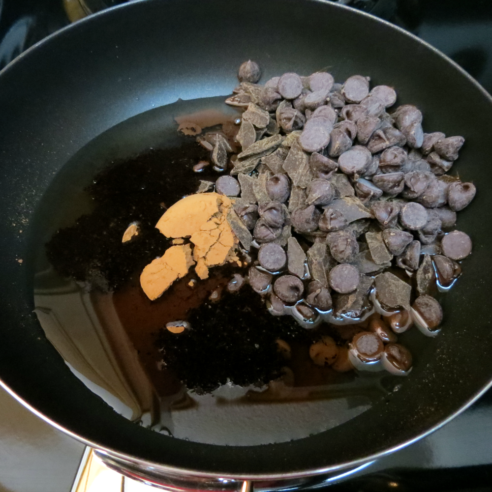 pan with chocolate chips, oil and coffee in it