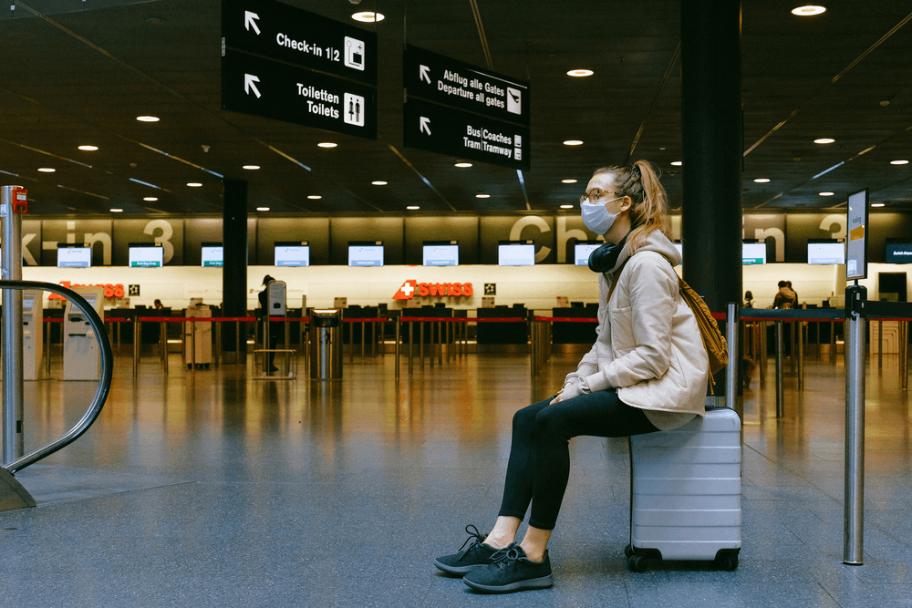 woman with a suitcase waiting at the airport