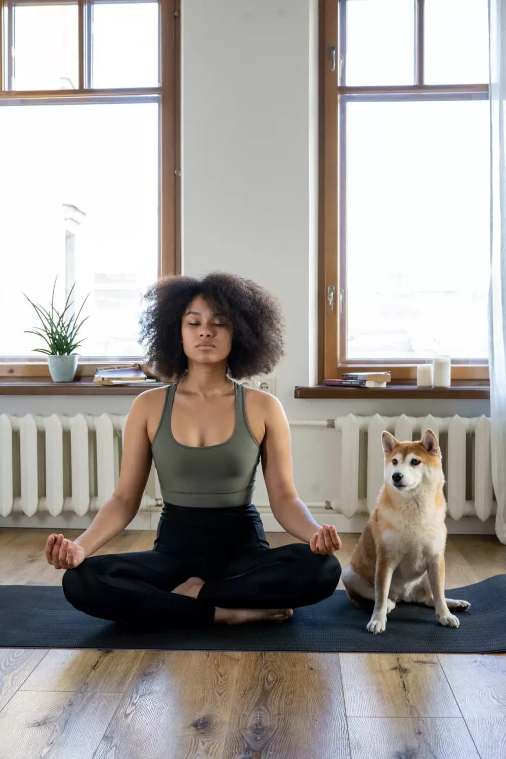 woman doing yoga with her dog