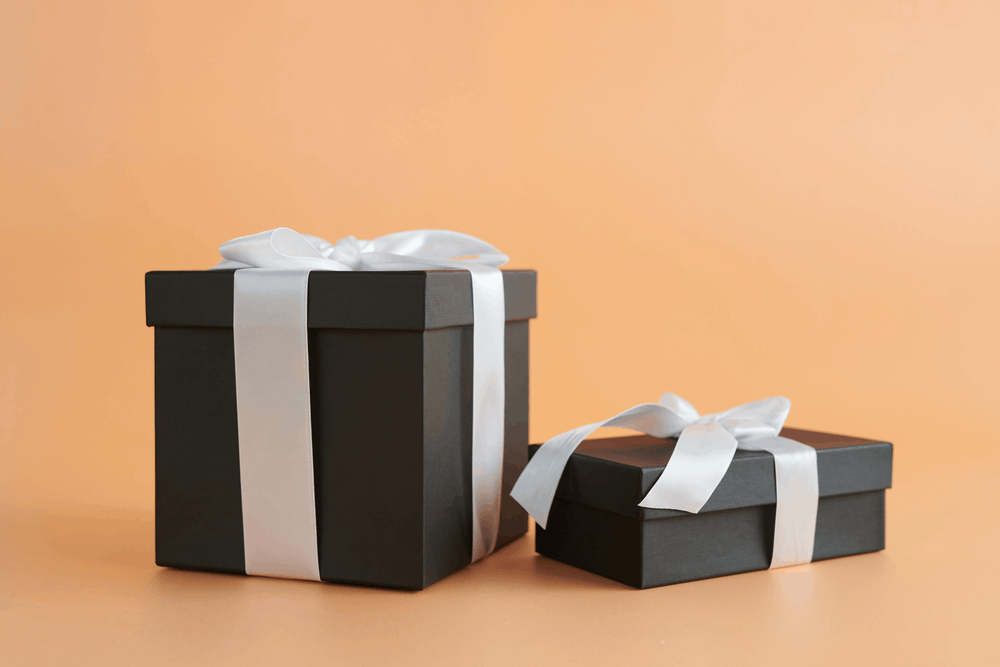 black gift boxes with white bows