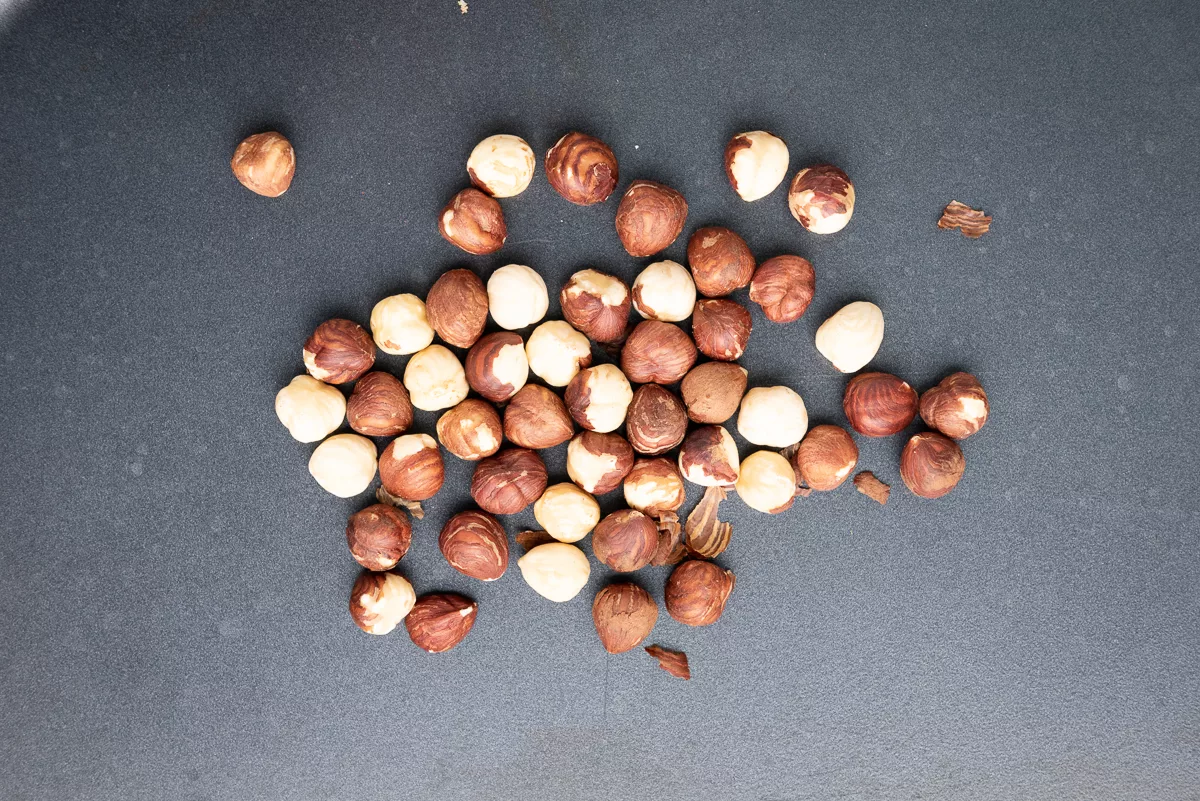 Overhead shot of roasted hazelnuts with skins removed. 