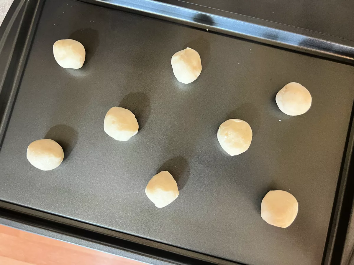 cookie dough balls on a baking sheet